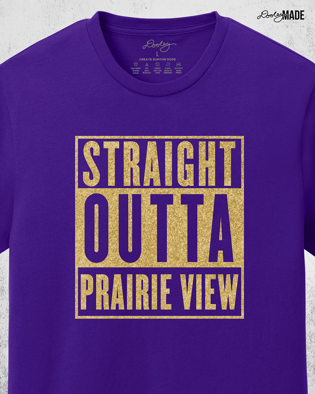 A purple Prairie View A&M University Shirt with "Straight Outta Prairie View" in a shinny golden design across the chest. Perfect for alumni, students, and gradates that want to celebrate their HBCU pride with a shine. Zoomed to show detail.