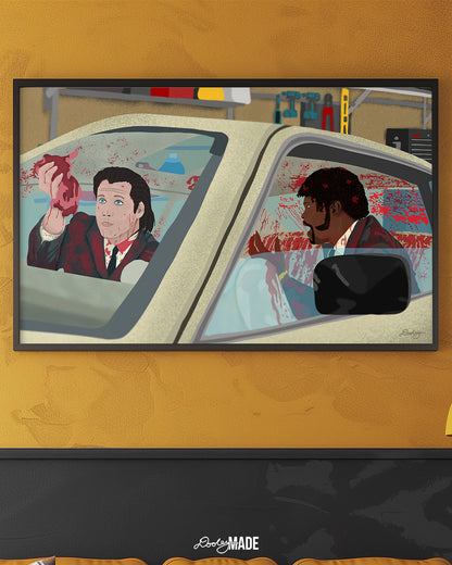 An image showing a framed photo of a stylized illustration by Dre Dooley titled "The Accident" depicting a scene from the movie Pulp Fiction on yellow/gold wall in a room. Covered in blood, Samuel L. Jackson and John Travolta argue while cleaning blood and brain from a car's interior as it sits in a garage. 