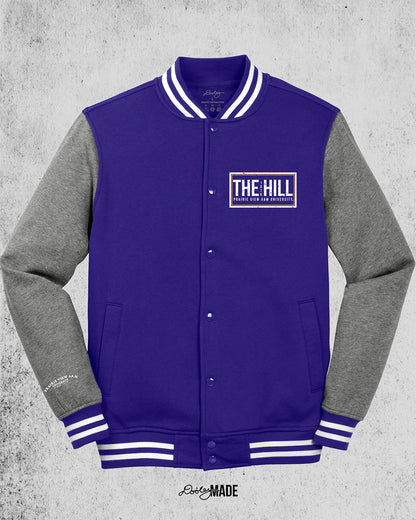 Purple and heather gray Prairie View A&M Fleece Varsity Letterman Jacket. The front left chest has 'The Hill' and 'Prairie View A&M University' text printed in white inside of a rectangular box.