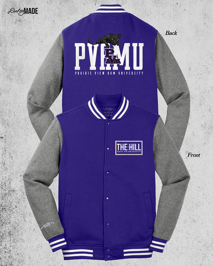 Image of the front and back of a purple and heather gray Prairie View A&M Fleece Varsity Letterman Jacket. Back has a print of a black panther laying atop 'PVAMU' text, with PVAM Logo overlayed, and 'Prairie View A&M University' text underneath. The front left chest has 'The Hill' text printed in white inside of a rectangular box.