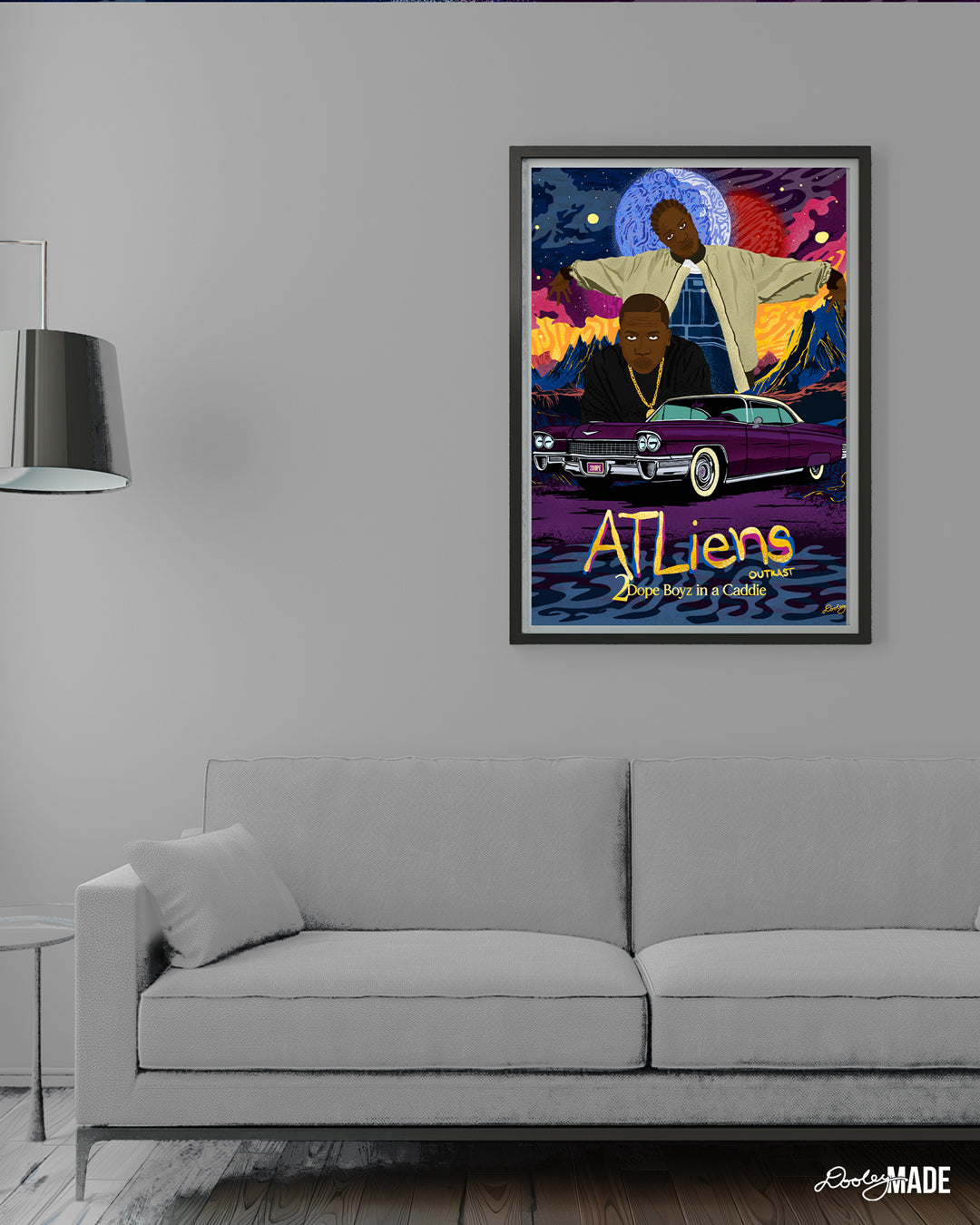 A custom OutKast illustration featuring an out of this world theme and an old school Cadillac, capturing the essence and colorful complexity of OutKast's extra-terrestrial rhymes. The artwork sits in a black frame in a white room above a white modern couch next to a lamp.