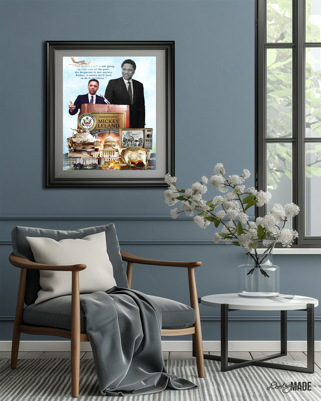 This image depicts a room with blue walls and a light-colored floor. There is a picture frame with a printed graphic collage of Congressman Mickey Leland that celebrates his life and accomplishments. There is a large window, allowing natural light to illuminate the space. Several objects are scattered throughout the room, including a chair with a soft blanket and a table with a vase of sparse white flowers. The overall atmosphere of the room is clean and organized.