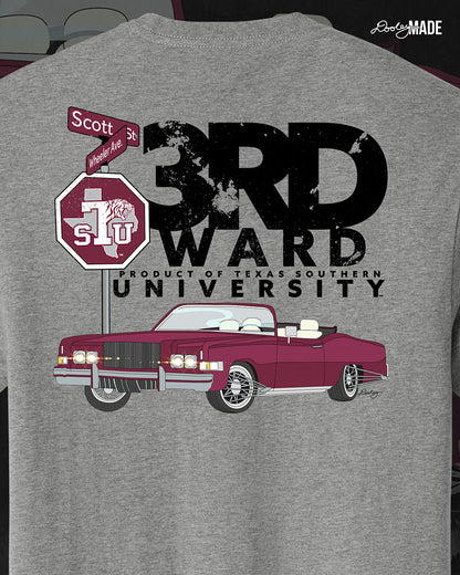 An image of the back of a heather gray Texas Southern University graphic tee shirt featuring a 3rd Ward University design and a maroon old school car with elbow rims. There is also a Scott St and Wheeler Ave street sign with a stop sign with the Texas Southern University logo on it. 