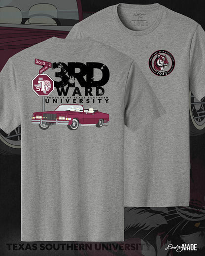 An image of the front and back of a heather gray Texas Southern University graphic tee shirt featuring a 3rd Ward University design and a maroon old school car with elbow rims. There is also a Scott St and Wheeler Ave street sign with a stop sign with the Texas Southern University logo on it. The front shows a circular print with the words Texas Southern University Established 1927 Houston, Tx  around the border with a stylized tiger inside of it. 