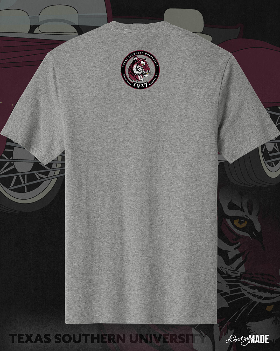 An image of the back of a heather gray Texas Southern University graphic tee shirt featuring a 3rd Ward University design and a maroon old school car with elbow rims. There is also a Scott St and Wheeler Ave street sign with a stop sign with the Texas Southern University logo on it. The the back shows a circular print with the words Texas Southern University Established 1927 Houston, Tx  around the border with a stylized tiger inside of it. 