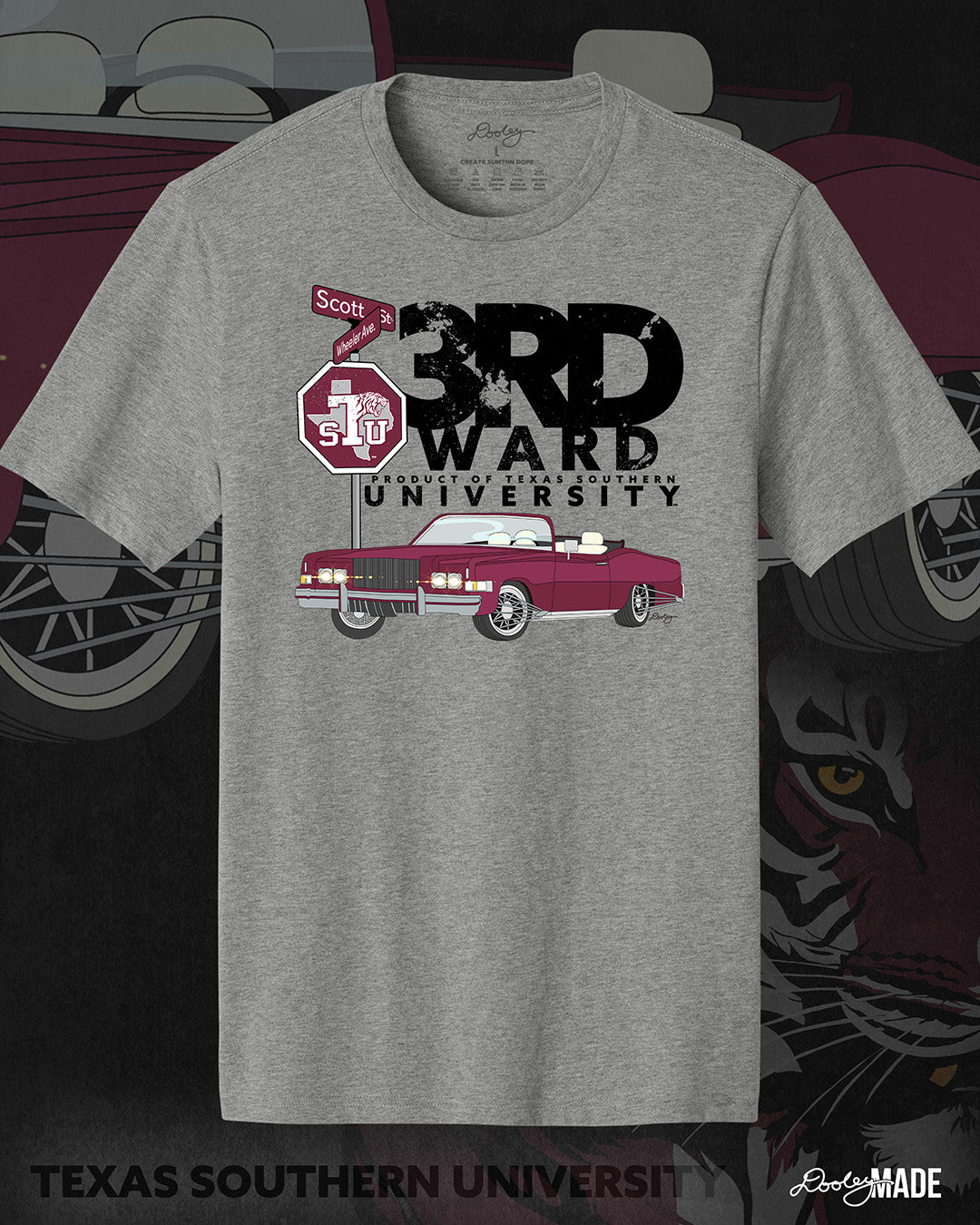 An image of the front of a heather gray Texas Southern University graphic tee shirt featuring a 3rd Ward University design and a maroon old school car with elbow rims. There is also a Scott St and Wheeler Ave street sign with a stop sign with the Texas Southern University logo on it.