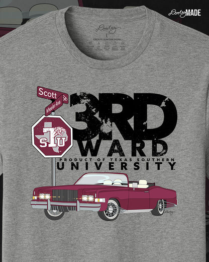 An image of the front of a heather gray Texas Southern University graphic tee shirt featuring a 3rd Ward University design and a maroon old school car with elbow rims. There is also a Scott St and Wheeler Ave street sign with a stop sign with the Texas Southern University logo on it.