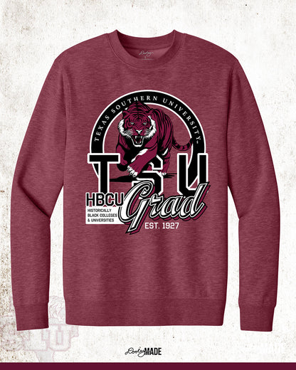 A heather maroon Texas Southern University graduation crewneck sweater featuring a prowling tiger surrounded by a circular frame with the university name inside of it, and the words "TSU Grad" next to HBCU and Historically Black Colleges & University.