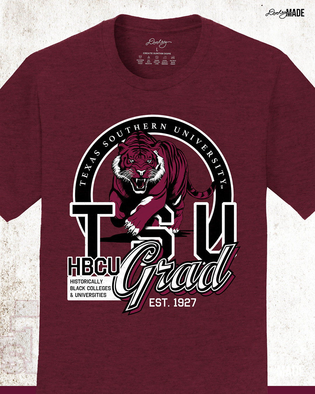 An athletic maroon Texas Southern University graduation shirt featuring a prowling tiger surrounded by a circular frame with the university name inside of it, and the words "TSU Grad" next to HBCU and Historically Black Colleges & University. Zoomed to show details.