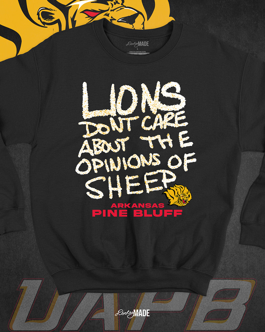The front  of a black University of Arkansas Pine Bluff graphic crewneck sweater with the slogan "Lions Don't Care About The Opinions of Sheep" on the front and the UAPB lion logo.