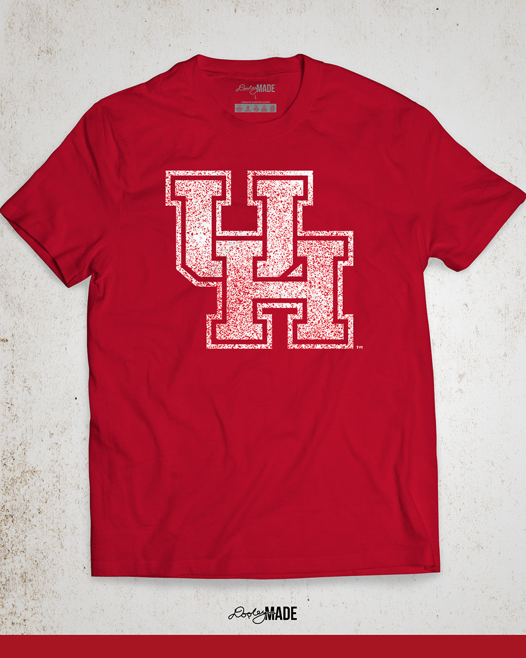 Image showing a red University of Houston shirt with a white UH logo with red speckles stretched across the front.