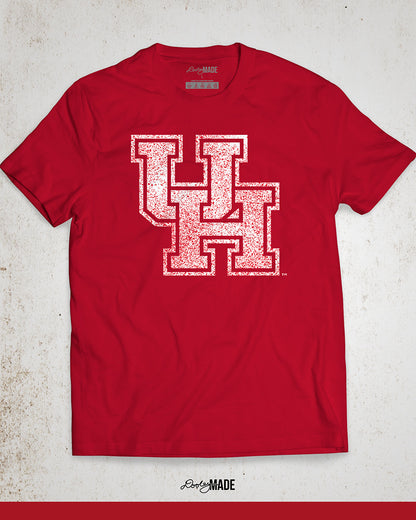 Image showing a red University of Houston shirt with a white UH logo with red speckles stretched across the front.