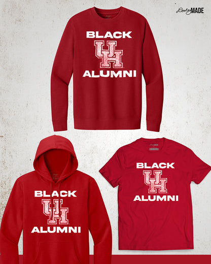 Image showing a variety of red University of Houston Black Alumni apparel in Crewneck Sweatshirt, Hoodie, and Shirt with bold, white text reading "BLACK ALUMNI" surrounding a speckled red "UH" logo in the center. The design highlights pride and unity for Black Alumni of the University of Houston, presented on a modern and stylish garment perfect for showing school spirit.