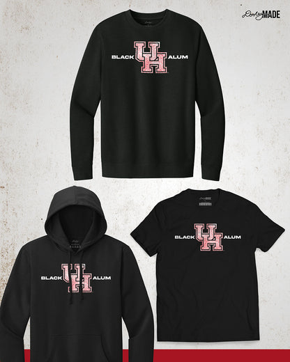 Image of a Black University of Houston Black Alumni crewneck sweater, shirt, and hoodie showcasing bold, white text reading "BLACK ALUM" flanking a speckled white and red "UH" logo in the center. The design emphasizes pride and unity for Black alumni of the University of Houston, presented on a stylish and modern garment ideal for representing school spirit and Cougar pride.