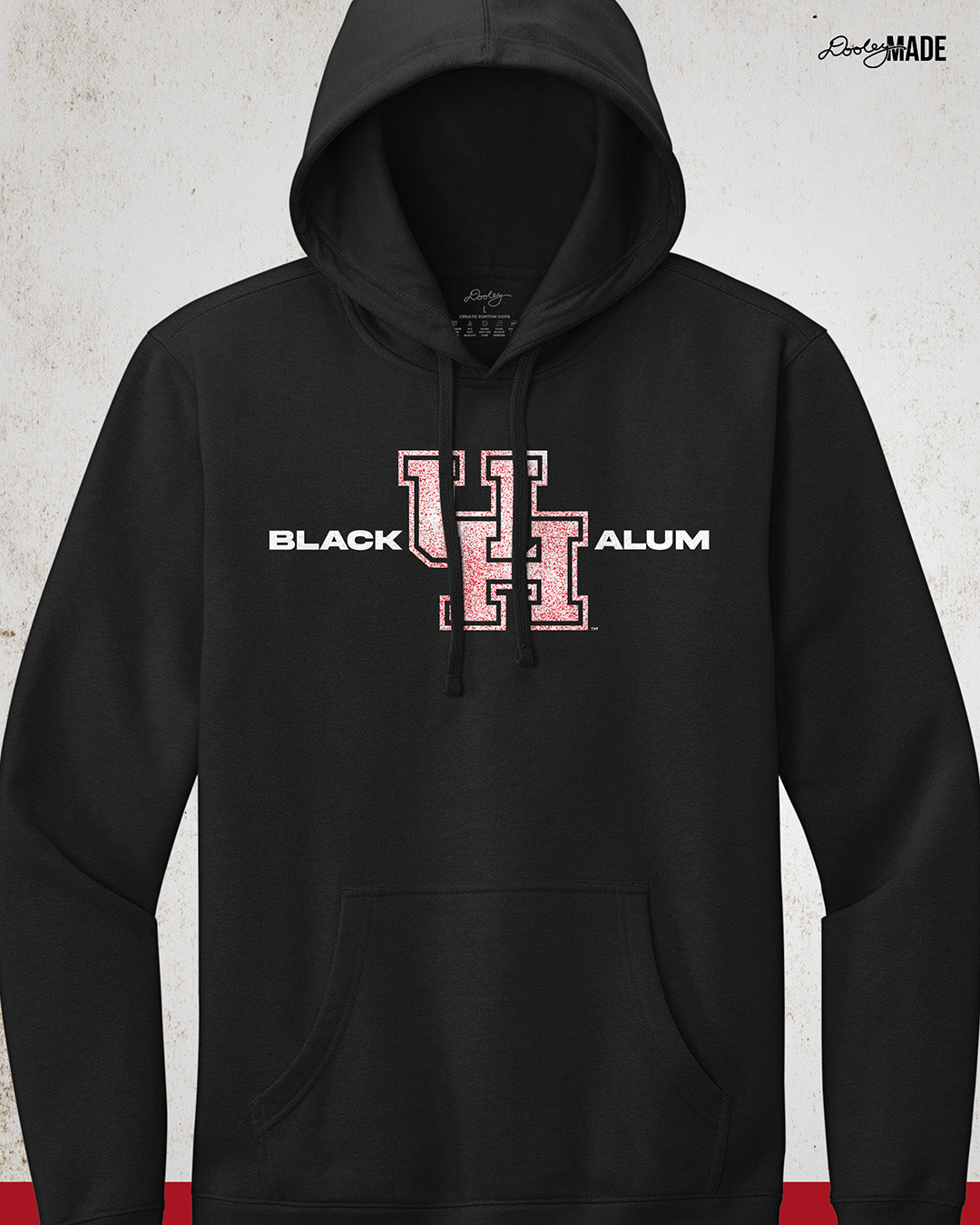 Image of a Black "Black UH Alumni Hoodie" showcasing bold, white text reading "BLACK ALUM" flanking a speckled white and red "UH" logo in the center. The design emphasizes pride and unity for Black alumni of the University of Houston, presented on a stylish and modern garment ideal for representing school spirit and Cougar pride.
