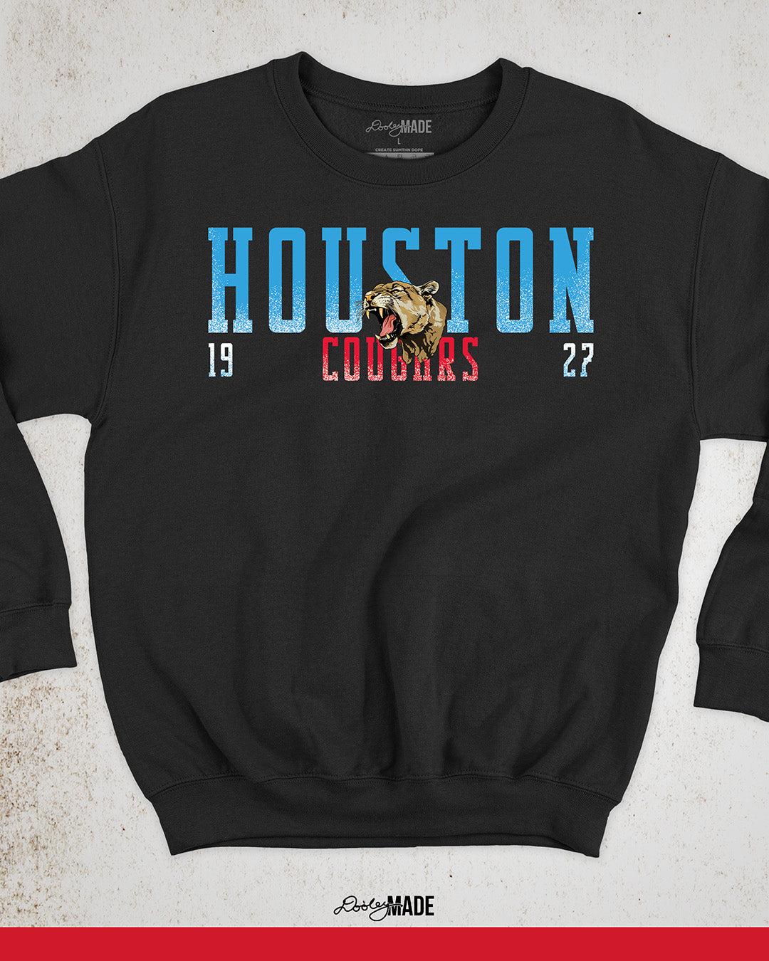 A black University of Houston Cougars themed crewneck sweatshirt with "Houston" written in Oiler Blue block text with a roaring cougar straddling the word Houston. The text "Cougars" is below in white and 1927 is split below in white. The text contains a white grunge texture on its lower half. Perfect for alumni, students, and fans.
