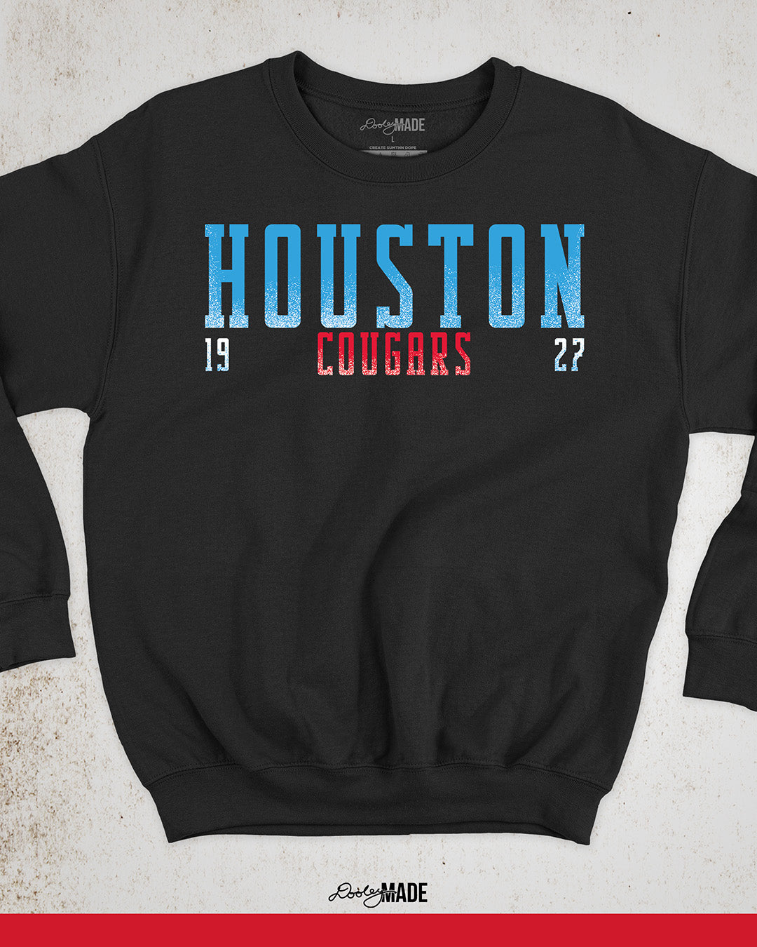 A black University of Houston Cougars themed hoodie with "Houston" written in Oiler Blue block text. The text "Cougars" is below in white and 1927 is split below in white. The text contains a white grunge texture on its lower half.
