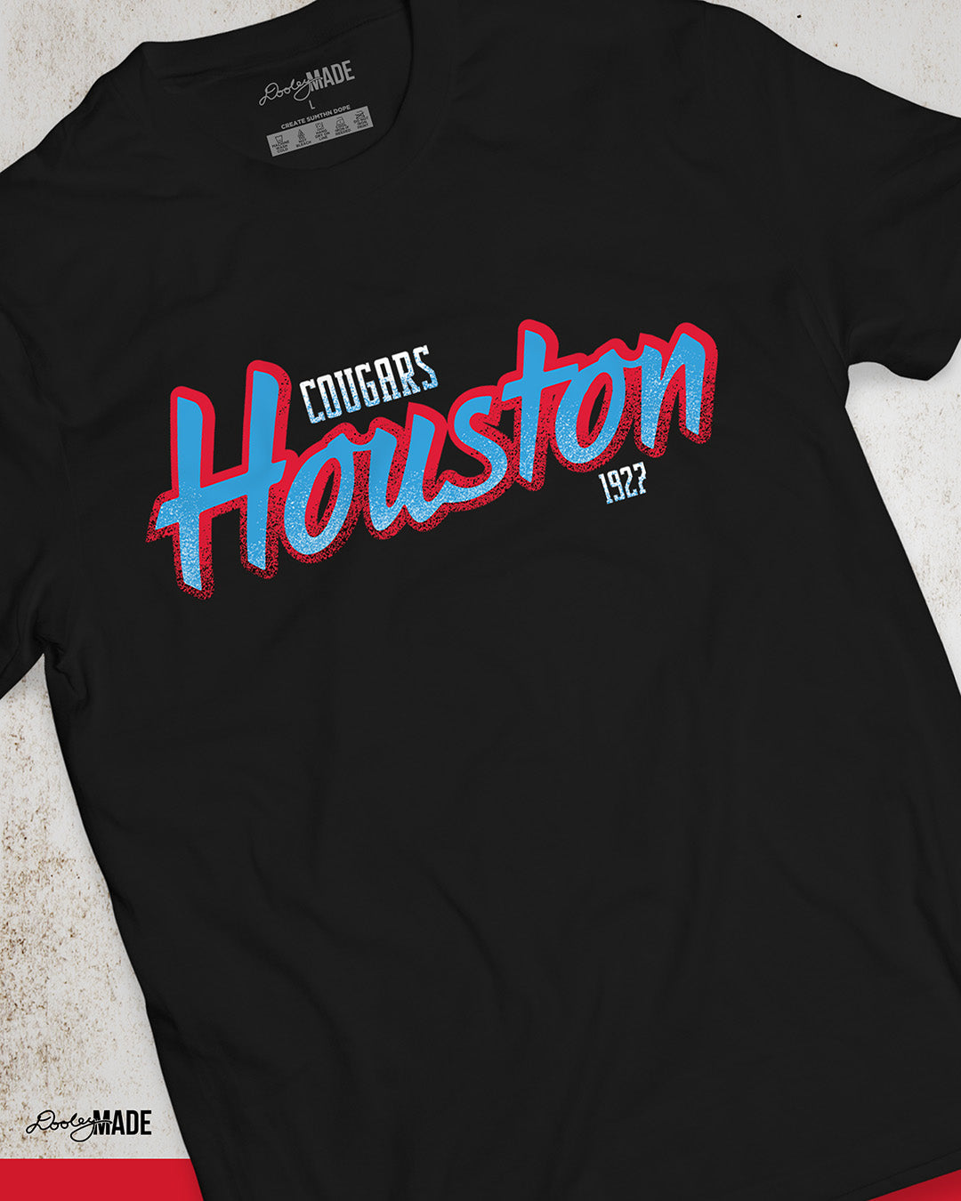 A black University of Houston Cougars themed crewneck sweatshirt with Houston written in Oiler Blue script text with a red outline. The text Cougars is above in white and 1927 is below in white. The text contains grunge texture on its lower half.