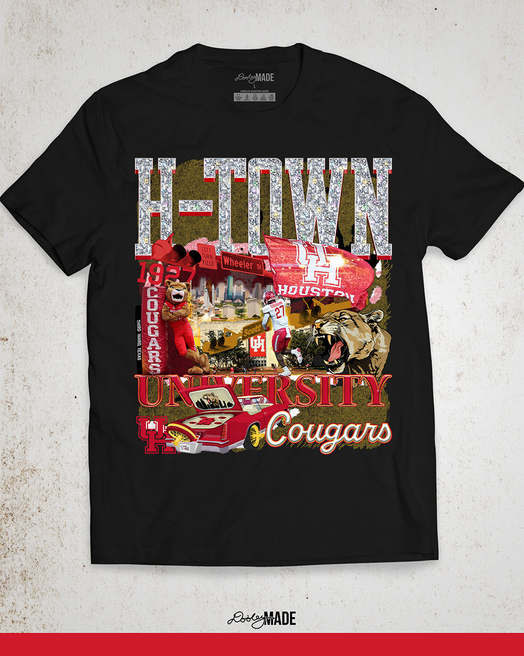 A black University of Houston themed shirt featuring a vibrant HTOWN University graphic collage with "H-TOWN" text in diamonds, Cougar mascot, players, city skyline, and classic lowrider in a vibrant collage design.