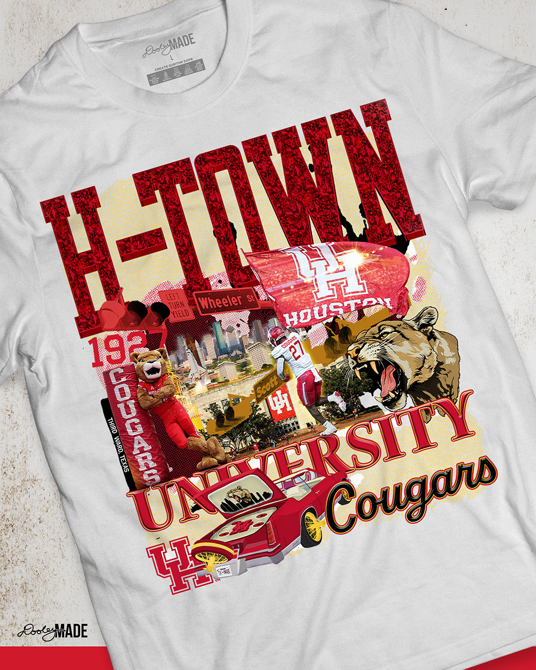A white University of Houston themed shirt featuring a vibrant HTOWN University graphic collage with "H-TOWN" text in diamonds, Cougar mascot, players, city skyline, and classic lowrider in a vibrant collage design.