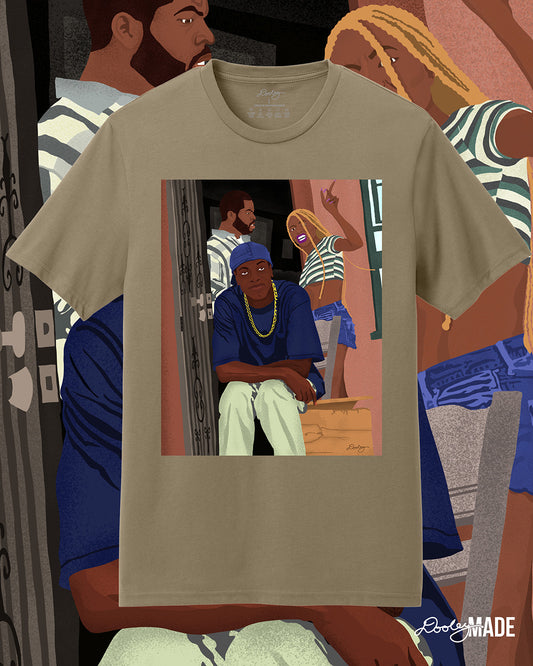 A tan Friday movie themed t-shirt with an illustration of movie character Craig being confront his girlfriend as sits in laughter. The artwork is enlarged in the background.