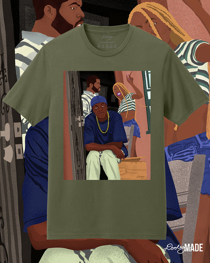 A military green Friday movie themed t-shirt with an illustration of movie character Craig being confronted on his front porch by his girlfriend as Smokie sits in laughter. The artwork is enlarged in the background.